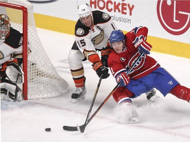 Montreal Canadiens Brendan Gallagher, right, shoots a backhand from a sharp angle while being checked by Anaheim Ducks Ryan Getzlaf next to Ducks goalie Frederik Andersen during second period of National Hockey League in Montreal Thursday December 18, 2014.