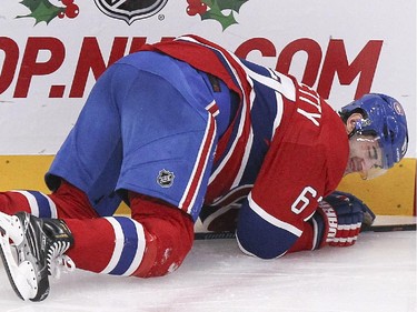 Montreal Canadiens Max Pacioretty grimaces as he tries to get up after check by Anaheim Ducks Clayton Stoner during third period of National Hockey League in Montreal Thursday December 18, 2014. Pacioretty left the game and didn't return.