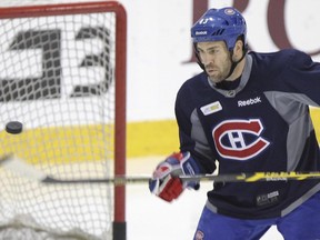 Canadiens defenceman Mike Weaver practices bouncing puck on his stick during practice at the team's training facility in Brossard on Dec. 19, 2014.