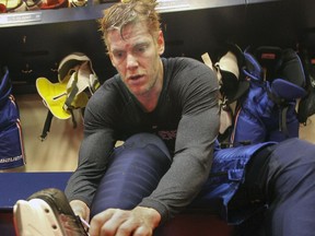 Canadiens defenceman Bryan Allen unlaces his skates after practice at the team's training facility in Brossard on Dec. 19, 2014.