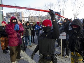 Police move in to help as city of Montreal workers cross a picket line past striking colleagues at the city's Louis-Charland administration building Dec. 2, 2014, during a 24-hour strike by the city's white collar workers.