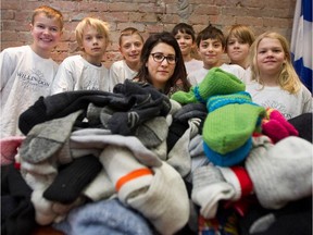 A group of students from Willingdon School donate 85 pairs of socks for residents of the Old Brewery Mission in Montreal on Monday December 22, 2014. Neila Ben-Ayed, centre, of the mission accepts the socks from the kids.