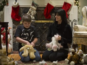Catherine Comtois and son Joshua stuff teddy bears at their home in St-Lambert, south of Montreal, Tuesday December 23, 2014.