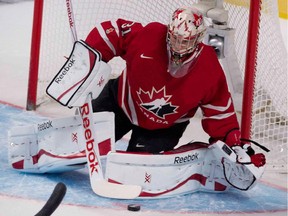 Team Canada goalie Zach Fucale makes a save against Switzerland during exhibition game on Dec. 23, 2014 at the Bell Centre before start of the World Junior Hockey Championship.