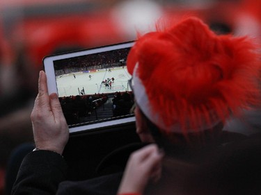 MONTREAL, QUE.: DECEMBER 26, 2014 -- A Team Canada fan shoots video with a tablet in the second period against Team Slovakia during a preliminary round hockey game at the IIHF World Junior Championship at the Bell Centre in Montreal, on Friday, December 26, 2014. The goal put the team up 4-0. (John Kenney / MONTREAL GAZETTE)