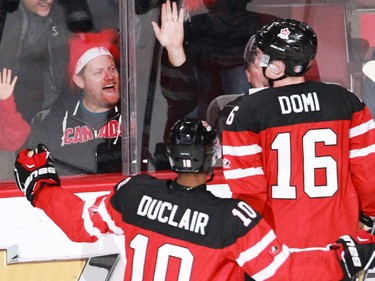 MONTREAL, QUE.: DECEMBER 26, 2014 -- Fans cheer for Max Domi of Team Canada, as teammate Anthony Duclair comes to congratulate him, after he'd scored against Team Slovakia in the second period of a preliminary round hockey game at the IIHF World Junior Championship at the Bell Centre in Montreal, on Friday, December 26, 2014. (John Kenney / MONTREAL GAZETTE)