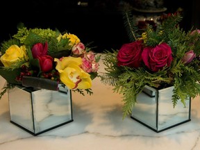 Roses, tulips and orchids get a holiday look with the addition of cedar, holly berries and pine cones at Flore.