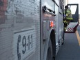 A firefighter climbs into his truck.