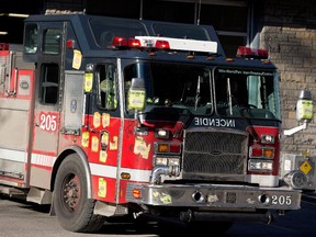Firefighters found a woman lying on the floor of her kitchen in Westmount Thursday night, covered in burns.