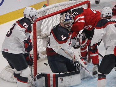 Curtis Lazar (26) of Team Canada scores goal on Team USA goalie Thacher Demko, while Zach Werensku, left, and J.T. Compher look on, during third period preliminary round hockey action at the IIHF World Junior Championship in Montreal on Wednesday December 31, 2014.
