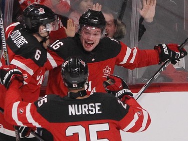 MONTREAL, QUE.: DECEMBER  31, 2014 -- Max Domi, facing camera, celebrates his goal for Team Canada with teammates Shea Theodore , left, and Darnell Nurse, during second period preliminary round hockey action at the IIHF World Junior Championship in Montreal on Wednesday December 31, 2014. (Pierre Obendrauf / MONTREAL GAZETTE)
