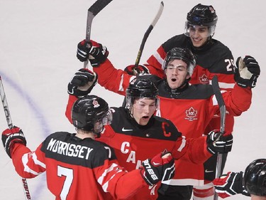 MONTREAL, QUE.: DECEMBER  31, 2014 -- Team Canada's Josh Morrissey, left, celebrates his goal with teammates captain Curtis Lazar, Nic Petan and Robby Fabbri, right, against Team USA, during second period preliminary round hockey action at the IIHF World Junior Championship in Montreal on Wednesday December 31, 2014. (Pierre Obendrauf / MONTREAL GAZETTE)