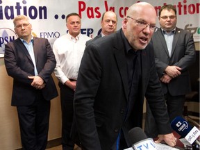 Marc Ranger, president of the Coalition syndicale pour la libre négotiation speaks at a press conference in Montreal at FTQ offices in Montreal Thursday.  The coalition of firefighters, police and municipal workers were reacting to the government's adoption of the pension reform bill, calling it a black day for municipal workers of Quebec. Behind him, from the left are: Denis Bolduc of CUPE, Daniel Pépin, SPQ president, Jean Gagnon, FISA president and Luc Boisvert, secretary of l'Association des Pompiers de Montréal.