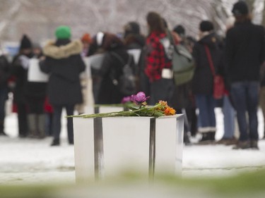 A bouquet of flowers sit atop one of the 14 memorial sculptures during a commemorative event at Parc du 6-Décembre-1989 in Montreal, Saturday December 6, 2014.  It was part of a day of commemorations to mark the 25th anniversary of the murder of 14 women at the École Polytechnique, by Marc Lépine.