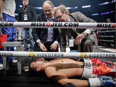 Doctors examine an unconscious Roberto Bolonti of Argentina after he was knocked out by Jean Pascal of Laval, not pictured, during their light heavyweight main event fight at the Bell Centre in Montreal on Saturday, December 6, 2014.