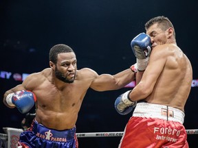 Jean Pascal of Laval, left, exchanges punches with Roberto Bolonti of Argentina during their light-heavyweight main event fight at the Bell Centre in Montreal on Saturday, December 6, 2014.