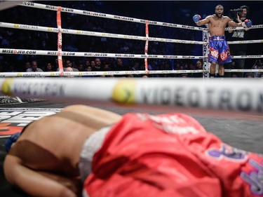 Jean Pascal of Laval, rear, reacts after a knocking out Roberto Bolonti of Argentina, front, during their light heavyweight main event fight at the Bell Centre in Montreal on Saturday, December 6, 2014.