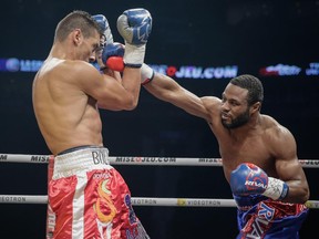 Laval's Jean Pascal, right, lands punch against Argentina's Roberto Bolonti during light-heavyweight fight at the Bell Centre on Dec. 6, 2014.