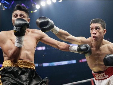 Joel Diaz Jr. of California, right, exchanges punches with Pedro Navarrese of Mexico, left, during their super featherweight boxing match at the Bell Centre in Montreal on Saturday, December 6, 2014.