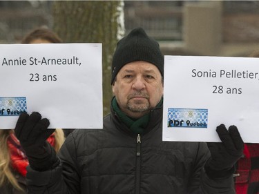 Pierre Cloutier holds placards with the names of two of 14 murder victims, during a commemorative event at Parc du 6-Décembre-1989 in Montreal, Saturday December 6, 2014.  It was part of a day of commemorations to mark the 25th anniversary of the murder of 14 women at the École Polytechnique, by Marc Lépine.