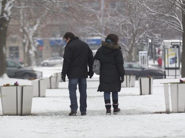 Pierre Samut, left, walks with his daughter Christine between memorial sculptures at Parc du 6-Décembre-1989 in Montreal, Saturday December 6, 2014.  It was part of a day of commemorations to mark the 25th anniversary of the murder of 14 women at the École Polytechnique, by Marc Lépine.