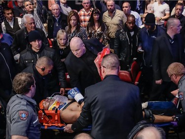 Roberto Bolonti of Argentina is escorted in a medical stretcher after being knocked out by Jean Pascal of Laval after their light heavyweight main event fight at the Bell Centre in Montreal on Saturday, December 6, 2014.
