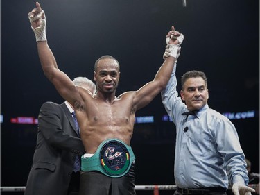 Schiller Hyppolite of Montreal receives his belt after beating Norbert Nemesapati of Hungary in their light heavyweight boxing match at the Bell Centre in Montreal on Saturday, December 6, 2014.
