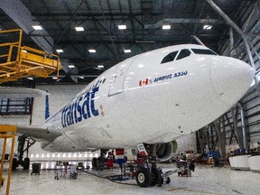 An Air Transat plane is seen in a hangar for regular maintenance at the Air Transat operations headquarters in St-Laurent