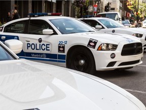 MONTREAL, QUE.: JULY 16, 2014 -- Unions upset with the government's pension reform have started a sticker campaign on Montreal city buses, police cars and other public property. Protest stickers have been applied to police cars at station 20 in downtown Montreal, on Wednesday, July 16, 2014. (Dave Sidaway / THE GAZETTE)  Web 4x3 ORG XMIT: POS1410031753463480