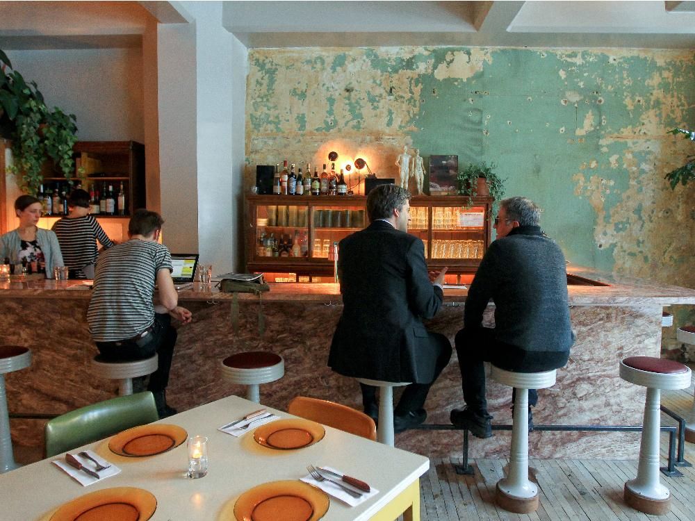 Peeling paint and reclaimed bar stools at Café Parvis.