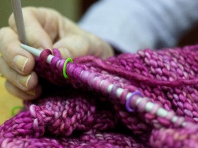 Frances Kalil checks her stitches during a gathering of her knitting group in Town of Mount Royal.
