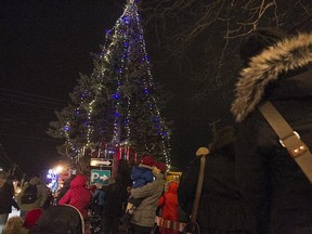 Lights beam from the Christmas tree during the annual lighting event in Pointe-Claire Village on Saturday, Nov. 29, 2014.