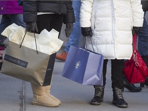 Shoppers walk along on Ste-Catherine Stt. W. on Saturday November 29, 2014. (Pierre Obendrauf / MONTREAL GAZETTE)