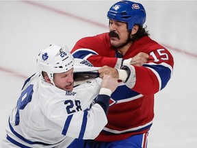 The Canadiens' George Parros fights with the Toronto Maple Leafs' Colton Orr during game at the Bell Centre on Oct. 1, 2013.