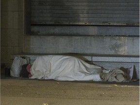 A homeless person takes shelter near the Pointe à Callière museum on Wednesday October 29, 2014.