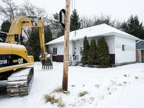 MONTREAL, QUE.: Saturday, December 6, 2014 --  An excavator sits outside houses on Poirier St in St-Lazare, that are to be demolished to create a new town square, just south of Bedard Park, Saturday, December 6, 2014. (Frederic Hore / MONTREAL GAZETTE)