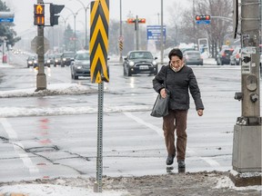 MONTREAL, QUE.: Saturday, December 6, 2014 --  Rosa Izarra, 70, of Pointe Claire scurries across the busy, seven-lane wide, Boul St-Jean intersection at Boul Brunswick in Pointe Claire, Quebec, Saturday, December 6, 2014. The working grandmother said she has to scamper across the street, because the traffic  delay is quite short. Residents have asked the city to increase the time permitted to traverse major intersections, to allow seniors and pedestrians more time to cross the busy thoroughfares. (Frederic Hore / MONTREAL GAZETTE)