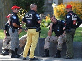 Montreal police officers wear unofficial work pants Sept. 4, 2014, in protest of Bill 3, the municipal pension reform bill proposed by the Quebec provincial government.