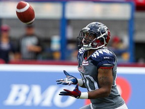 MONTREAL, QUE.: SEPTEMBER 07, 2014 -- Montreal Alouettes kick returner Tyrell Sutton catches a punt from Hamilton Tiger Cats kicker Justin Medlock during Canadian Football League game in Montreal Sunday September 07, 2014.  (John Mahoney  / THE GAZETTE) ORG XMIT: 50842-0167