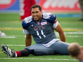 Alouettes linebacker Chip Cox stretches  during warmup before CFL game against the Hamilton Tiger-Cats at Molson Stadium on Sept. 7, 2014.