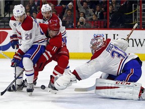 Carolina Hurricanes' Jordan Staal (11) battles between Montreal Canadiens' Nathan Beaulieu (28) and goalie Carey Price (31) during the second period of an NHL hockey game in Raleigh, N.C., Monday, Dec. 29, 2014.