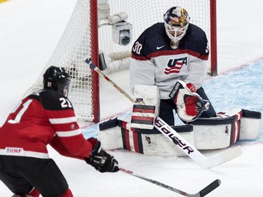 USA goaltender Thatcher Demko makes a save off Canada's Nick Ritchie during first period preliminary round hockey action at the IIHF World Junior Championship, Wednesday, December 31, 2014 in Montreal.