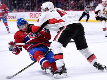 Chris Phillips of the Ottawa Senators sends Sven Andrighetto of the Montreal Canadiens to the ice during the NHL game at the Bell Centre on December 20, 2014, in Montreal.