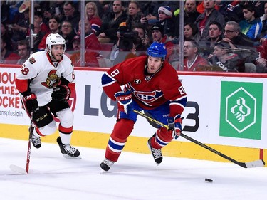 Brandon Prust of the Montreal Canadiens skates with the puck while being chased by Mike Hoffman of the Ottawa Senators during the NHL game at the Bell Centre on December 20, 2014, in Montreal.
