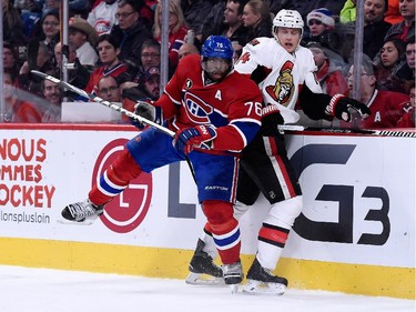 Colin Greening  of the Ottawa Senators body checks P.K. Subban of the Montreal Canadiens during the NHL game at the Bell Centre on December 20, 2014, in Montreal.