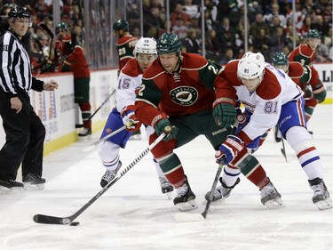Montreal Canadiens right wing P.A. Parenteau (15), Minnesota Wild defenceman Keith Ballard (2) and Canadiens centre Lars Eller (81), of Denmark, chase the puck during the second period of an NHL hockey game in St. Paul, Minn., Wednesday, Dec. 3, 2014.