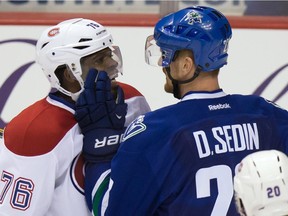 The Canadiens' P.K. Subban and the Canucks' Daniel Sedin exchange words during game in Vancouver on Oct. 30, 2014. The Canucks won 3-2 in overtime.