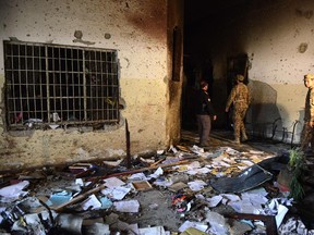 Pakistani soldiers walk amidst the debris in an army-run school a day after an attack by Taliban militants in Peshawar on December 17, 2014.  Pakistan began three days of mourning on December 17 for the 132 schoolchildren and nine staff killed by the Taliban in the country's deadliest ever terror attack as the world united in a chorus of revulsion. The 141 people were killed when insurgents stormed an army-run school in the northwestern city of Peshawar and systematically went from room to room shooting children during an eight-hour killing spree.