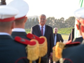 Palestinian President Mahmoud Abbas reviews troops on his arrival at Algiers airport, Sunday, Dec. 21, 2014. Abbas is in Algeria for a three-day state visit.