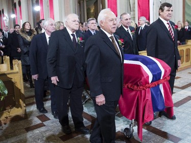 Pallbearers and former teammates (left to right) Dickie Moore, Jean-Guy Talbot, Phil Goyette, Yvan Cournoyer, Guy Lafleur and Serge Savard carry the casket of former Montreal Canadiens captain Jean Béiveau into his funeral service at Mary Queen of the World Cathedral in Montreal, Wednesday, Dec.10, 2014.
